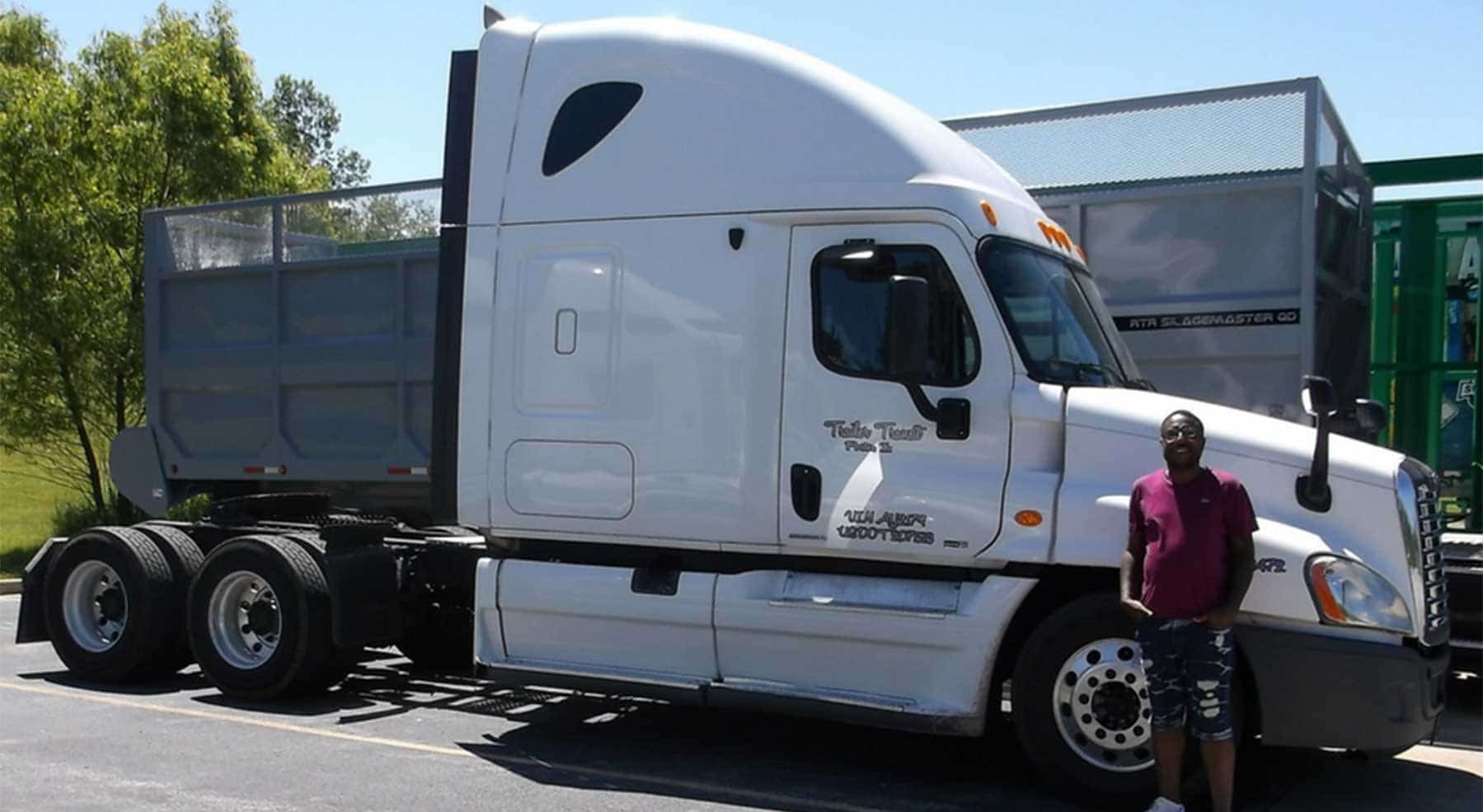 Trailer Transit Inc. | A man standing in front of a white semi truck.