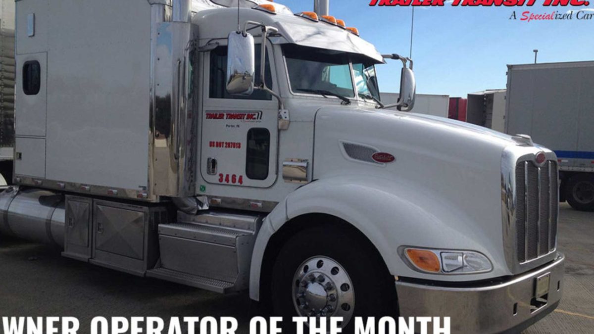 Trailer Transit Inc. | A white semi truck with the words power operator of the month.
