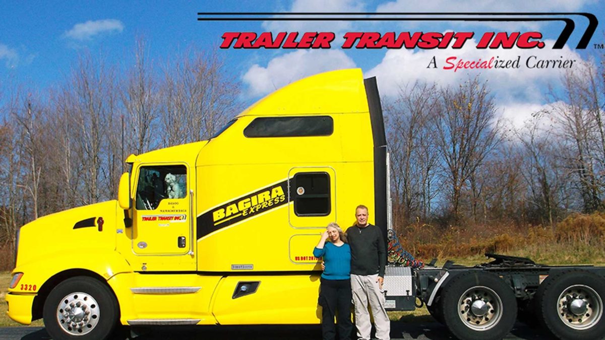 Trailer Transit Inc. | A man and woman standing in front of a yellow semi truck in April 2018.