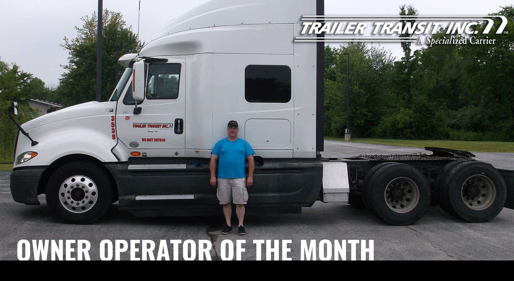 Trailer Transit Inc. | A man standing in front of a white semi truck with the words owner operator of the month.