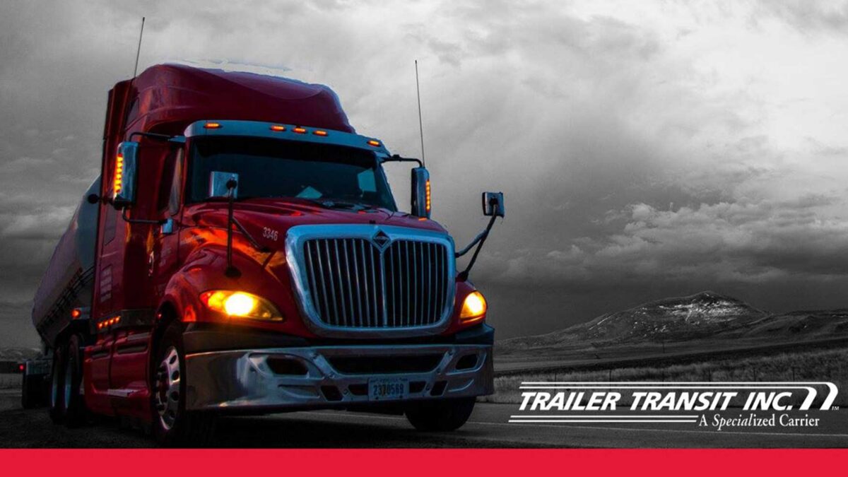 Trailer Transit Inc. logo on photo of red truck hauling on the road