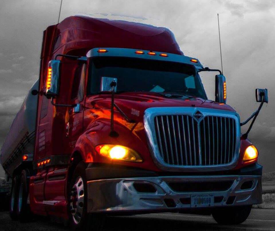 red Trailer Transit Inc. on the road with ominous sky