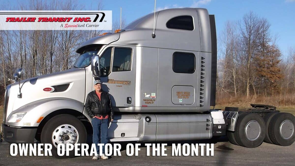 Trailer Transit Inc. | A woman standing in front of a truck with the words owner operator of the month.