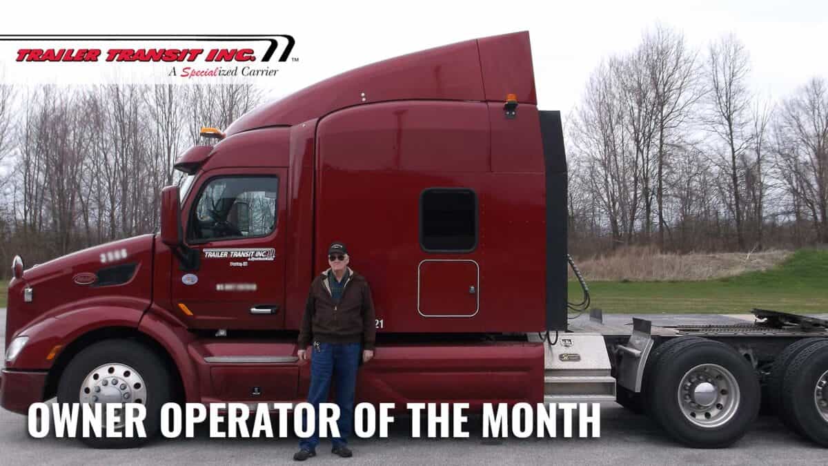 Trailer Transit Inc. | A man standing in front of a truck with the words owner operator of the month.