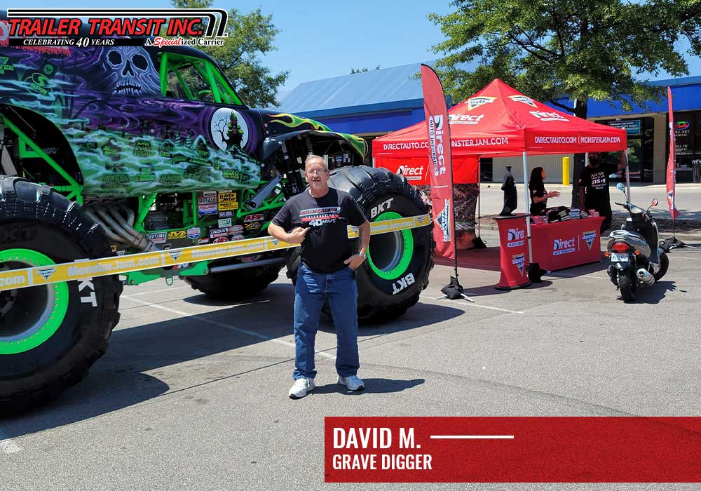 Trailer Transit, Inc. Owner Operator David in front of Grave Digger monster truck