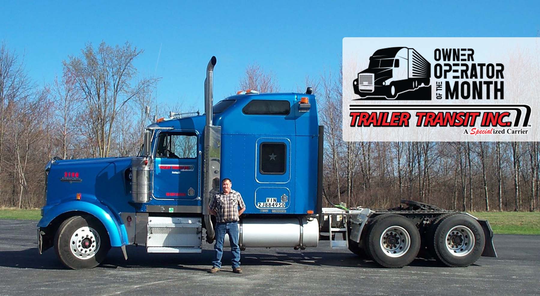 Trailer Transit Inc. | An award-winning owner operator of the month standing in front of a semi truck.