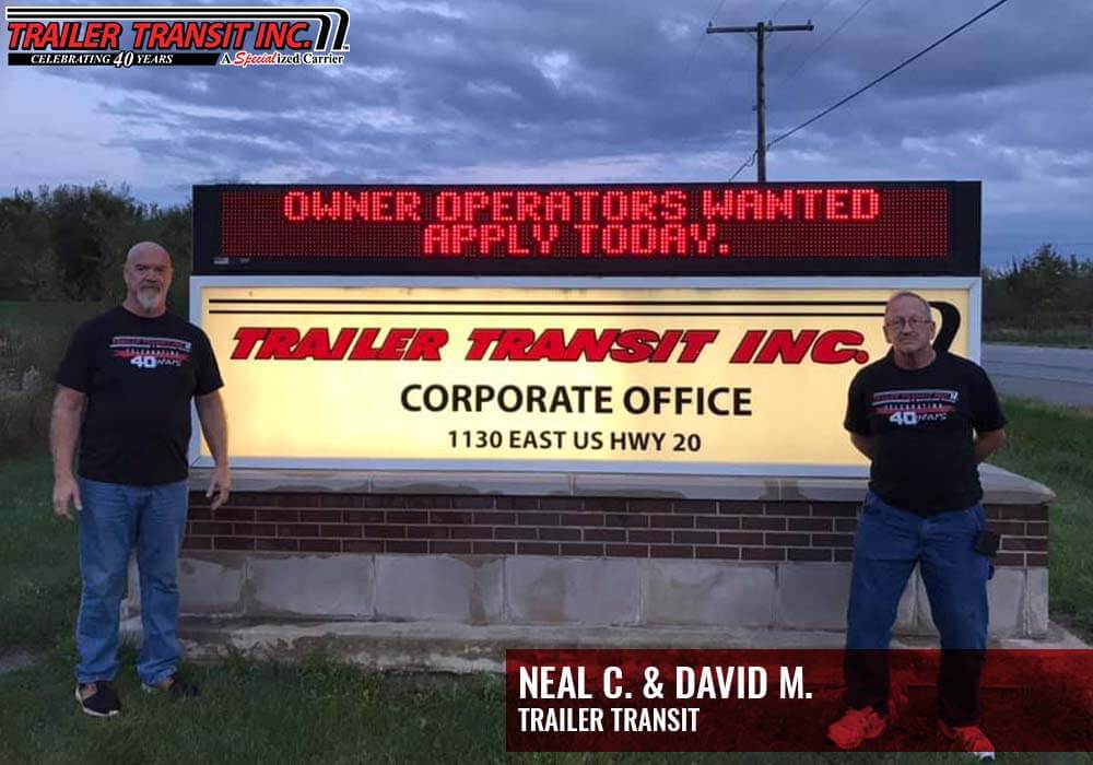 Trailer Transit Inc., drivers Neal & David in front of the company sign - Owner Operators Wanted