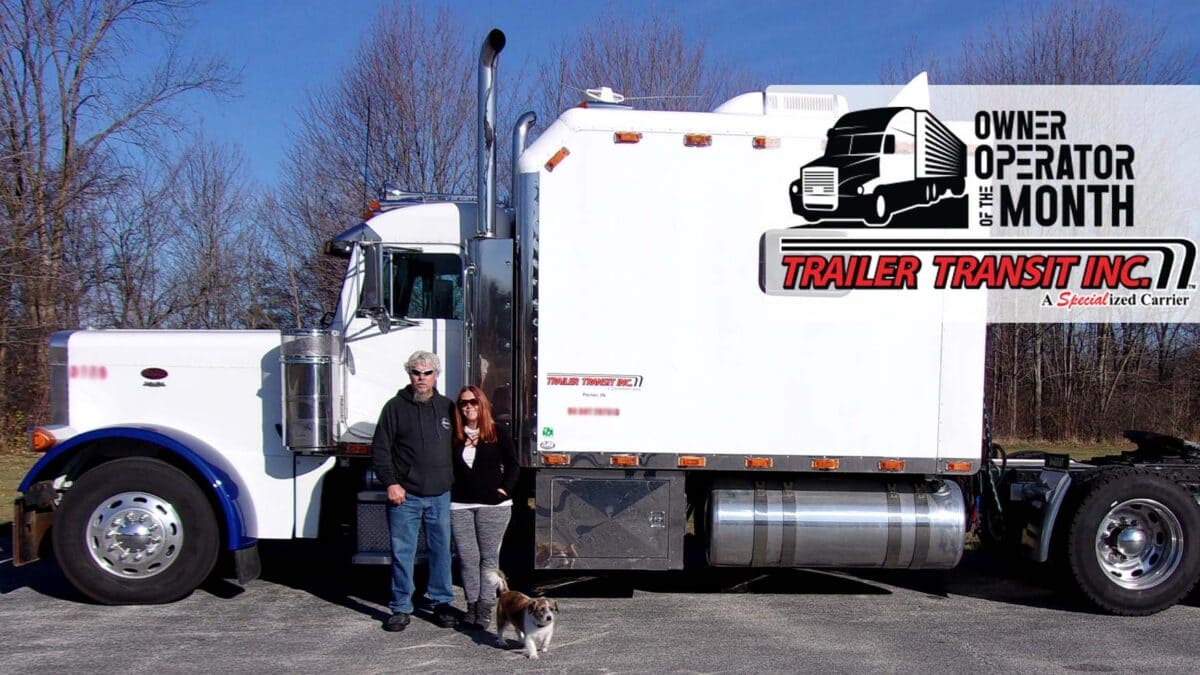 Trailer Transit Inc. | An owner operator and a woman standing in front of a semi truck.