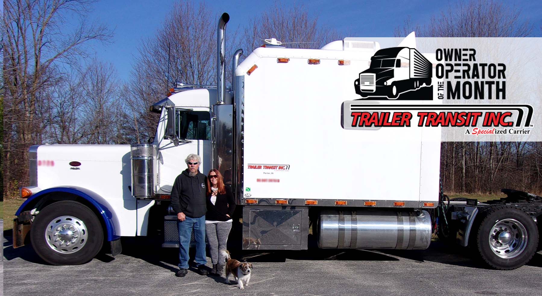 Trailer Transit Inc. | An owner operator and a woman standing in front of a semi truck.