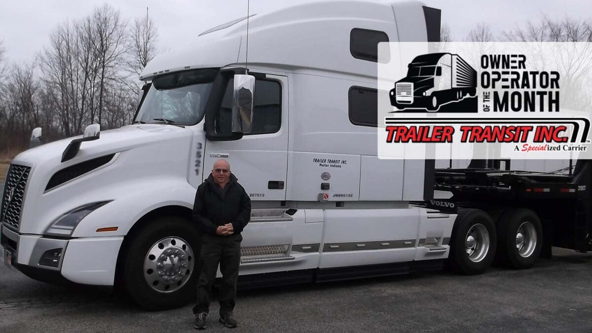 Trailer Transit Inc. | An owner operator standing in front of a white semi truck.