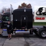 Trailer Transit Inc. | February 2022 Owner Operator of the Month standing in front of a black semi truck.