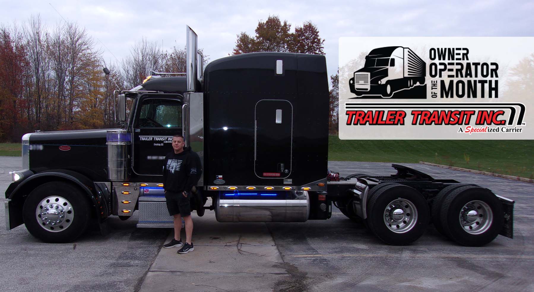 Trailer Transit Inc. | February 2022 Owner Operator of the Month standing in front of a black semi truck.