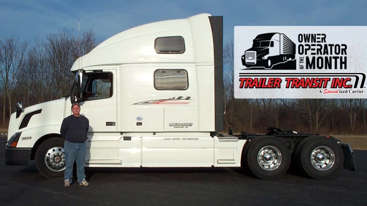 Trailer Transit Inc. | A man standing in front of a semi truck.