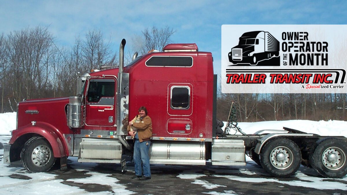 Trailer Transit Inc. | A woman standing next to a semi truck in the snow.