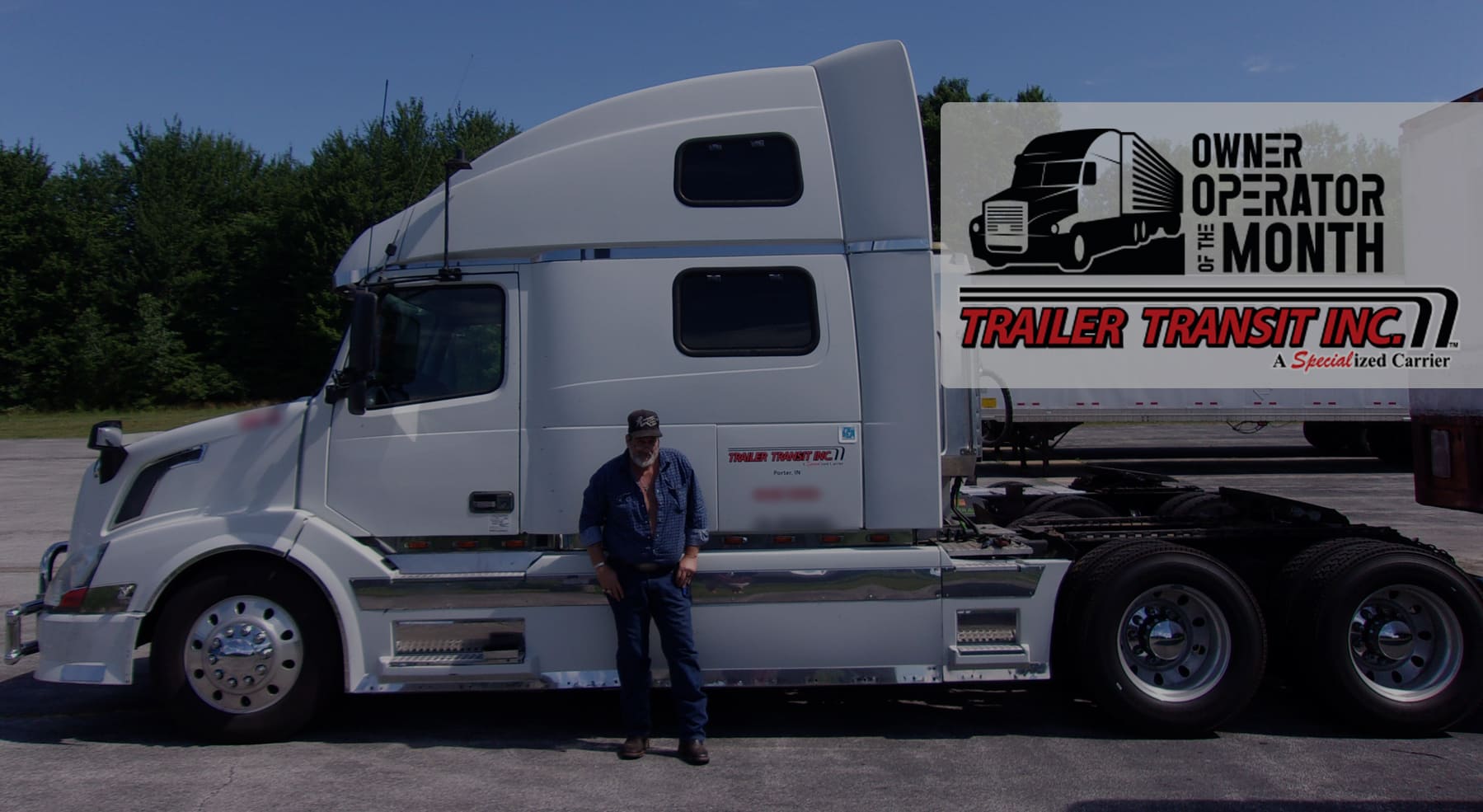 Trailer Transit Inc. | A man standing in front of a white semi truck.