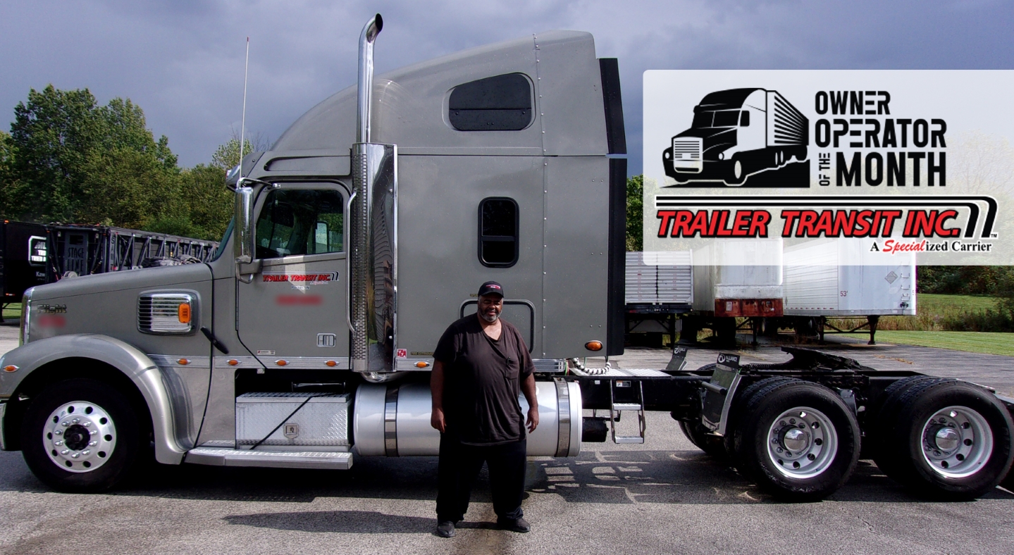 Trailer Transit Inc. | A man standing in front of a semi truck.