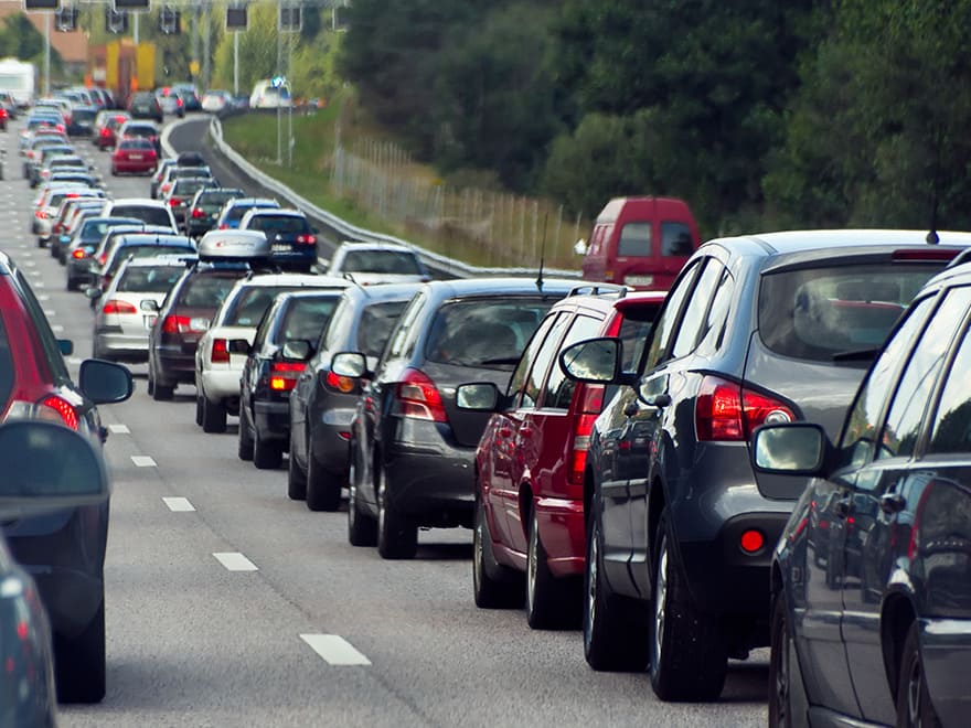 Trailer Transit Inc. | A long line of cars on a highway, illustrating the benefits of Dash Cams for Owner Operators/Power Only Drivers.