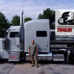 Trailer Transit Inc. | A man standing in front of a truck.