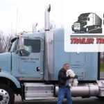 Trailer Transit Inc. | A man proudly standing next to a semi truck, showcasing his achievement as the Owner Operator of the Month.