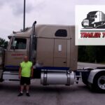 Trailer Transit Inc. | A man standing in front of a semi truck, recognized as the Owner Operator of the Month.