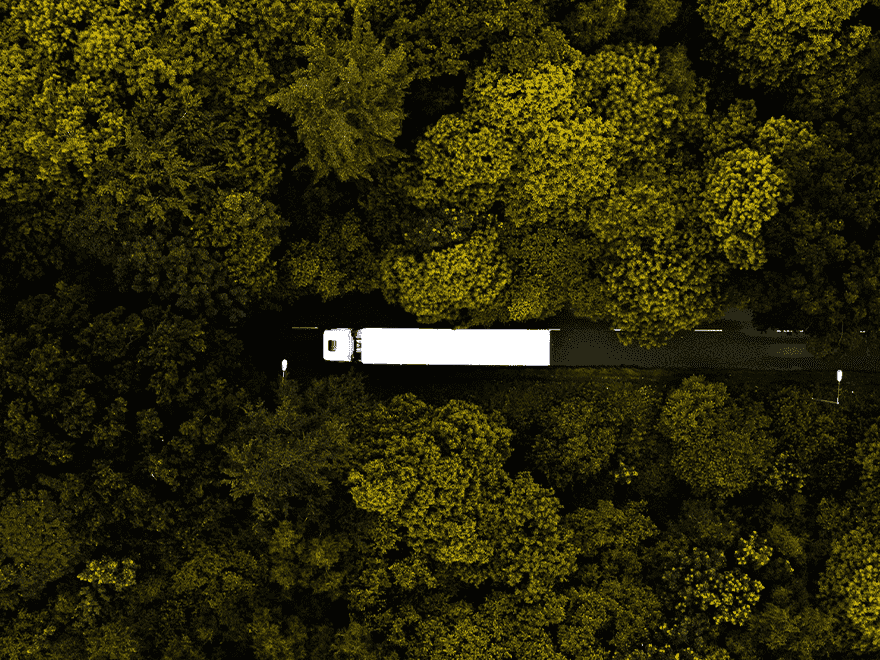 TT-BlogImage-0523-ArticleImages2 Trailer Transit Inc. | An aerial view of an Owner Operator Transport Companies truck parked in the middle of a forest.