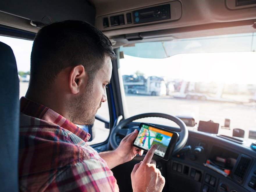 Driver using GPS in truck cab