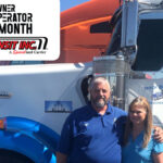 Trailer Transit Inc. | An Owner Operator of the Month standing in front of a semi truck.