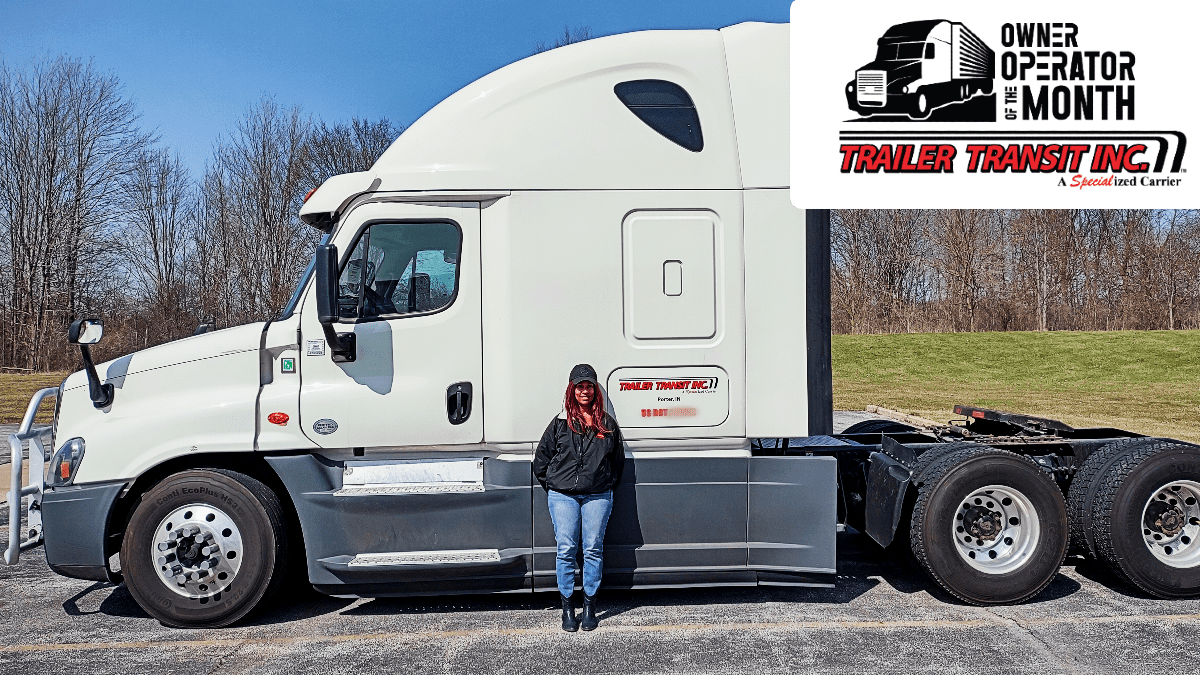 Trailer Transit Inc. | The Owner Operator of the Month proudly poses next to her white semi truck.
