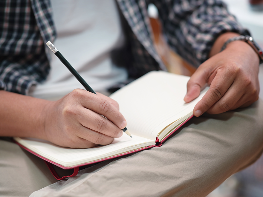 Trailer Transit Inc. | Driver writing in a log or journal.