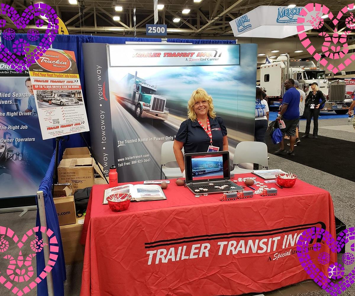 Trailer Transit Inc. | Recruiter, Audrey, standing in front of a the Trailer Transit booth at a truck show, where Owner Operators can meet them.