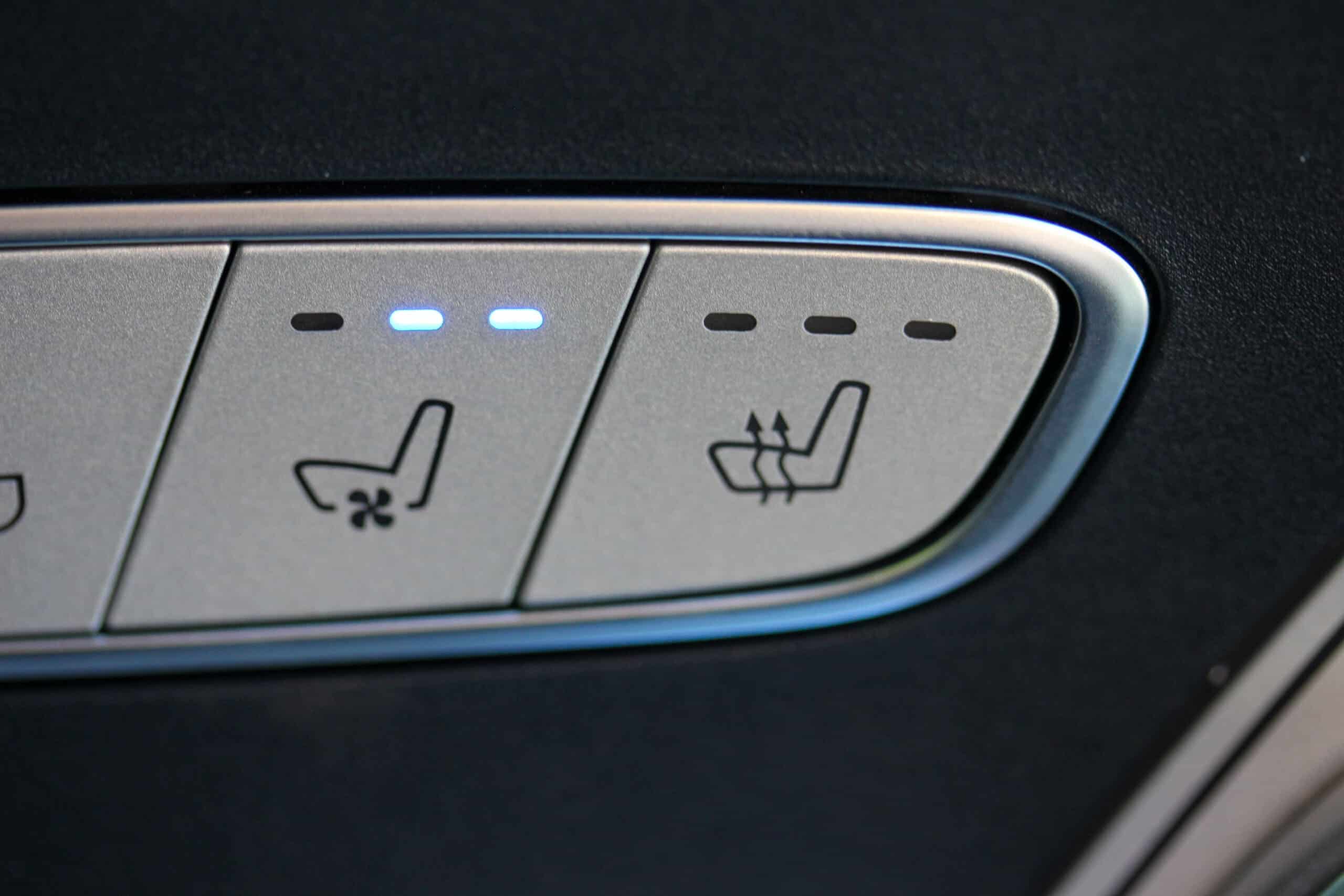 Climate seat buttons Trailer Transit Inc. | Close-up of car seat control buttons for seat ventilation.