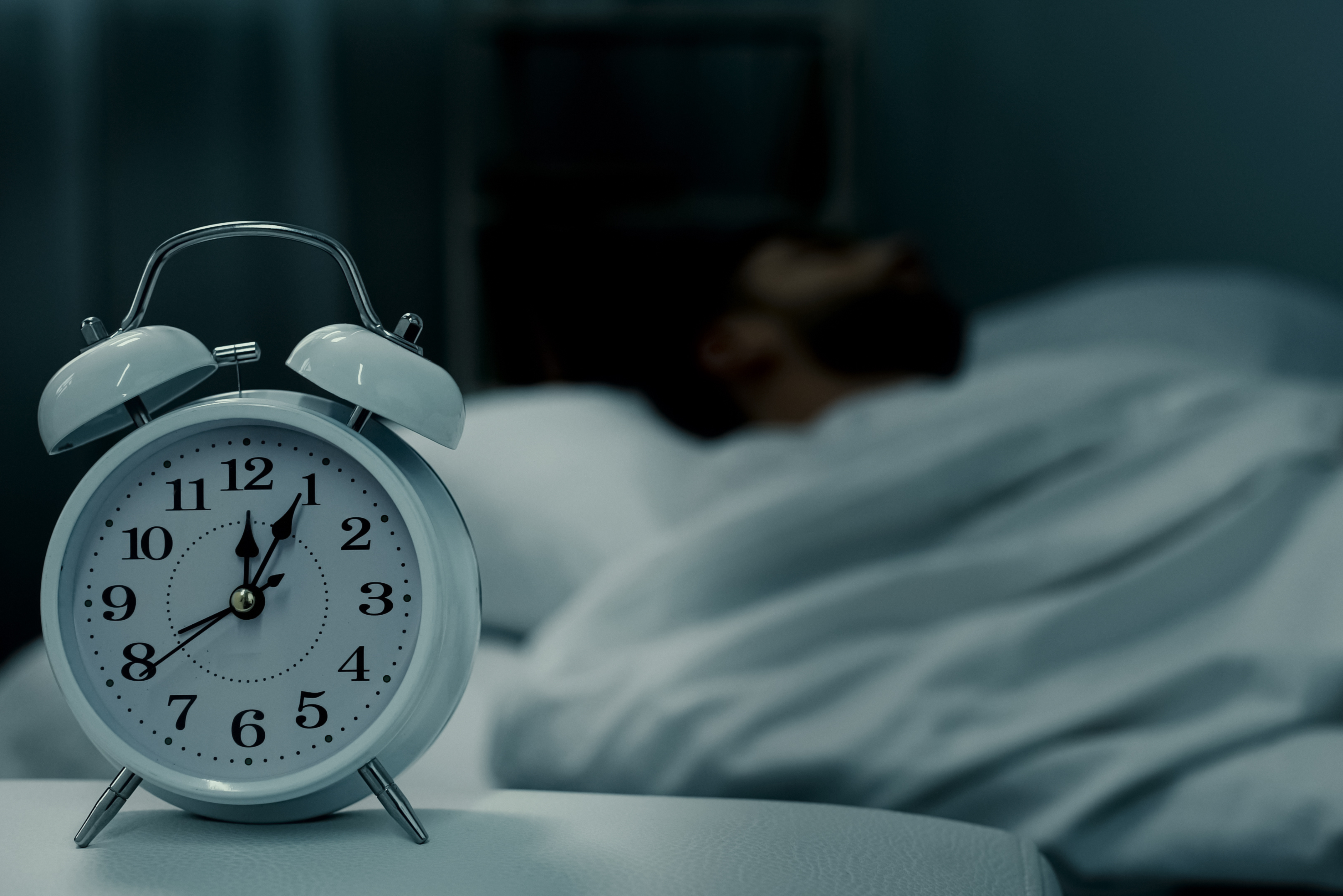 3 Trailer Transit, Inc | alarm clock sitting on a desk with sleeping man in the background