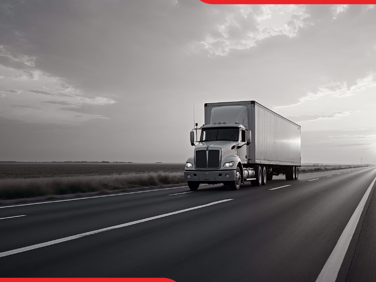 TT Blog0125_LoveTravel_A Trailer Transit Inc. | A large truck cruises along an open highway under a cloudy sky.