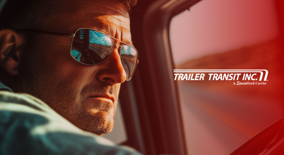 Trailer Transit Inc. | An owner operator wearing sunglasses in the cab of his rig; face reflected in the window. The logo "Trailer Transit Inc. A Specialized Power-Only Trucking Carrier" is displayed on the right side.