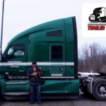 Trailer Transit Inc. | Owner Operator of the Month for May, Doug, stands in front of his green semi-truck. The "Owner Operator of the Month" and "Trailer Transit Inc." logos are displayed in the top right corner, celebrating outstanding owner operator achievement.