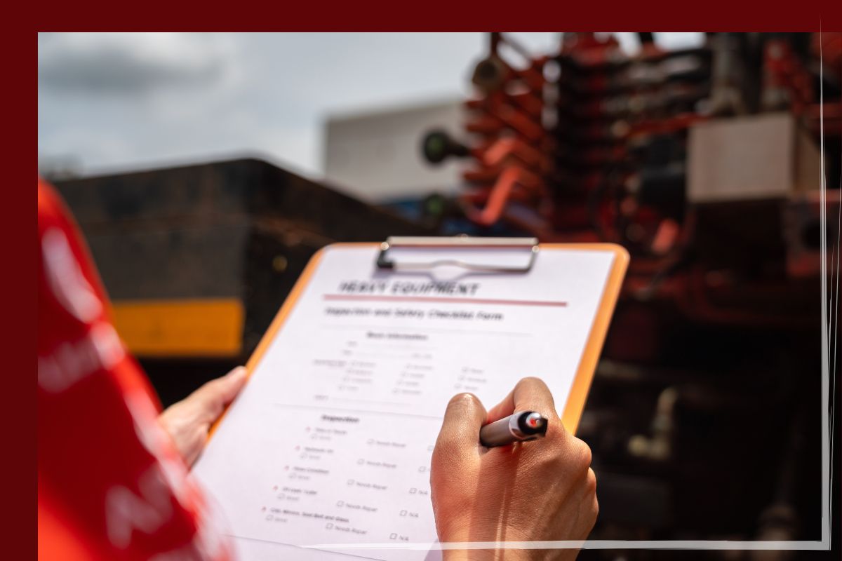 Trailer Transit Inc. | Power Only Driver holding a clipboard and pen, filling out inspection and safety paperwork.