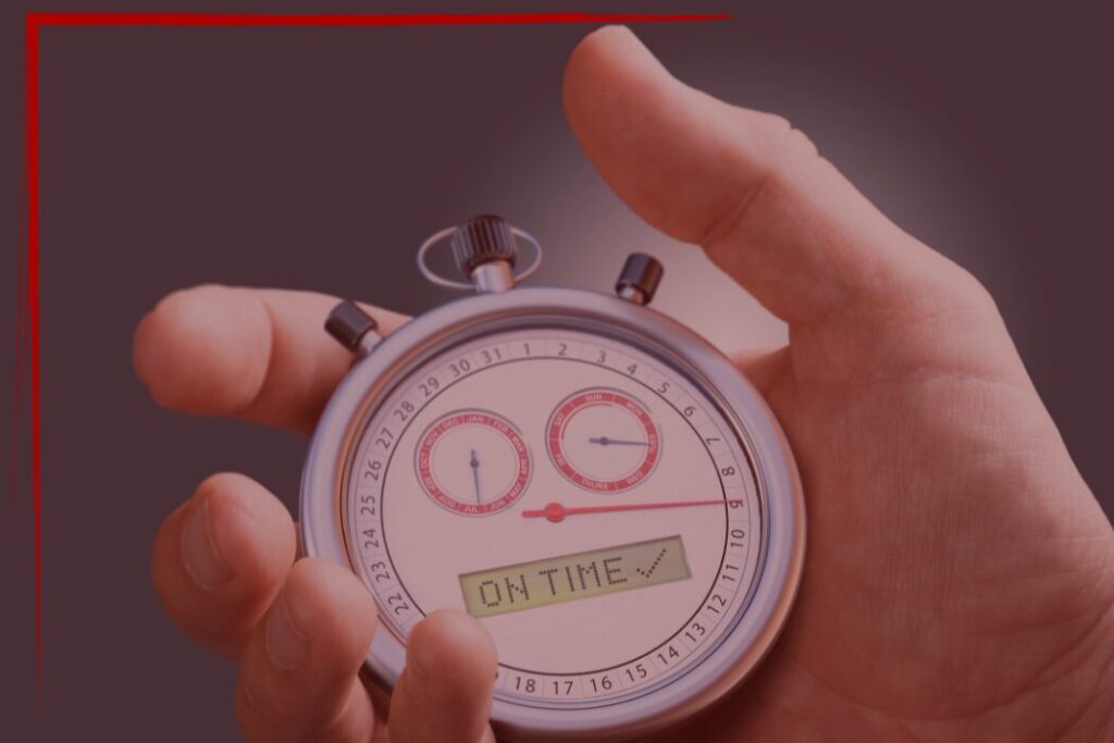 0126 Blog-3 Trailer Transit Inc. | A hand holds a stopwatch displaying the message "ON TIME" with a check mark on its digital screen, symbolizing the reliability of power-only trucking with a companion.