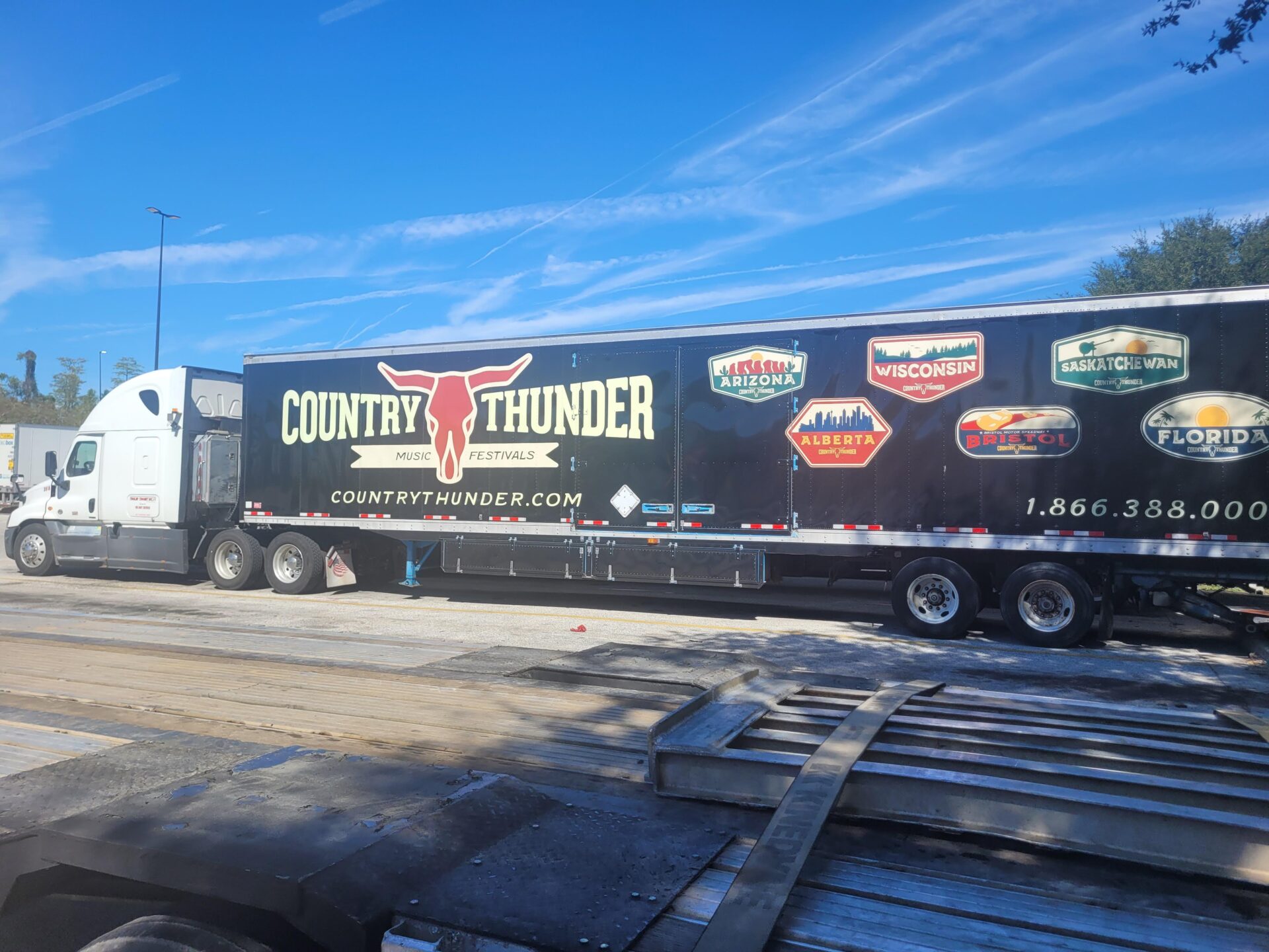 Country Thunder trlr (#3918 Frakes) Trailer Transit Inc. | A black semi truck with stickers on it, representing the best owner operator company.