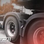 Trailer Transit Inc. | An Owner Operator holding a clipboard inspects his rig, carefully reviewing a truck and trailer maintenance checklist so he's prepared for seasonal hauls; the Trailer Transit Inc. logo is visible in the lower left corner.