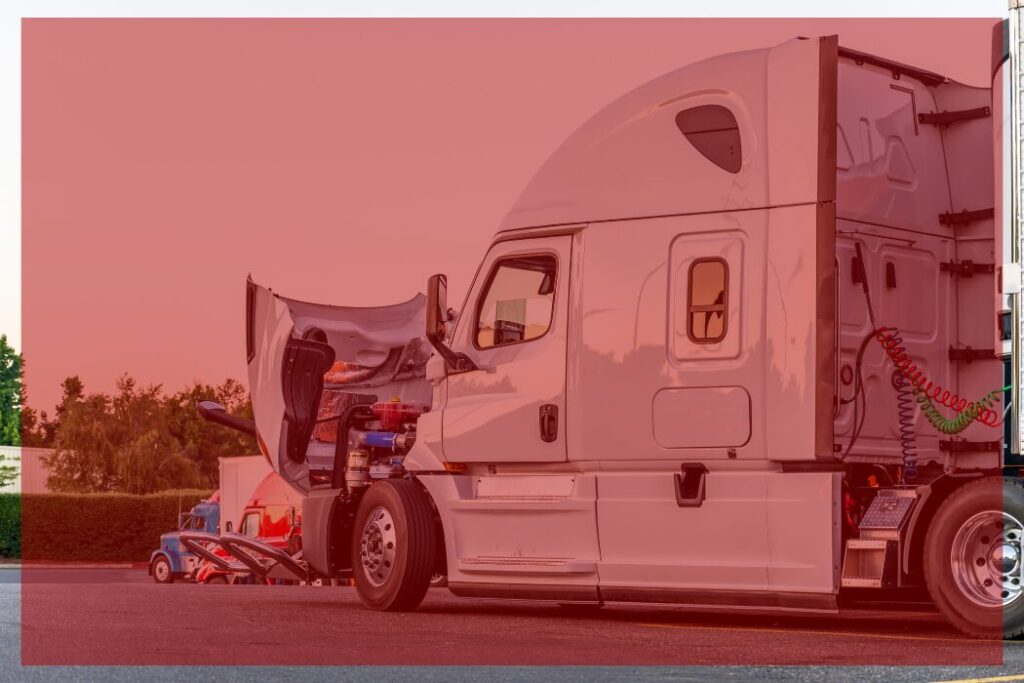Trailer Transit Inc. | A white semi-truck with its hood open is parked in a lot during daylight, highlighting how power-only drivers should go through their maintenance checklist before starting seasonal hauls.