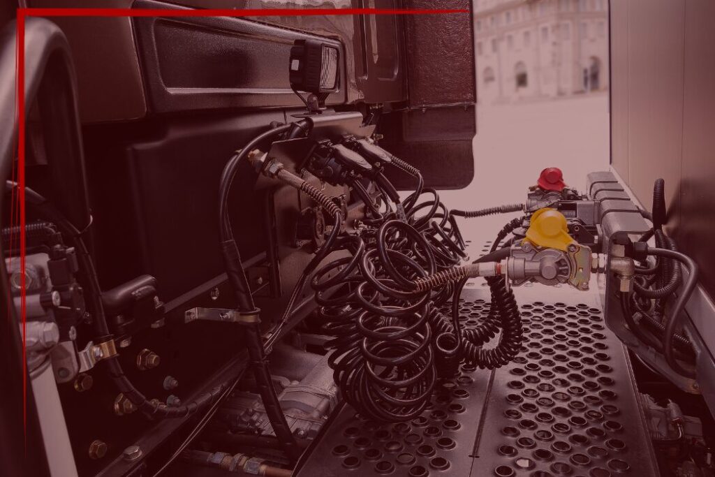Trailer Transit Inc. | Close-up view of truck air brake hose connections and couplings, with coiled cables and metal fittings visible—showcasing one area that must be maintained by Power-only drivers.