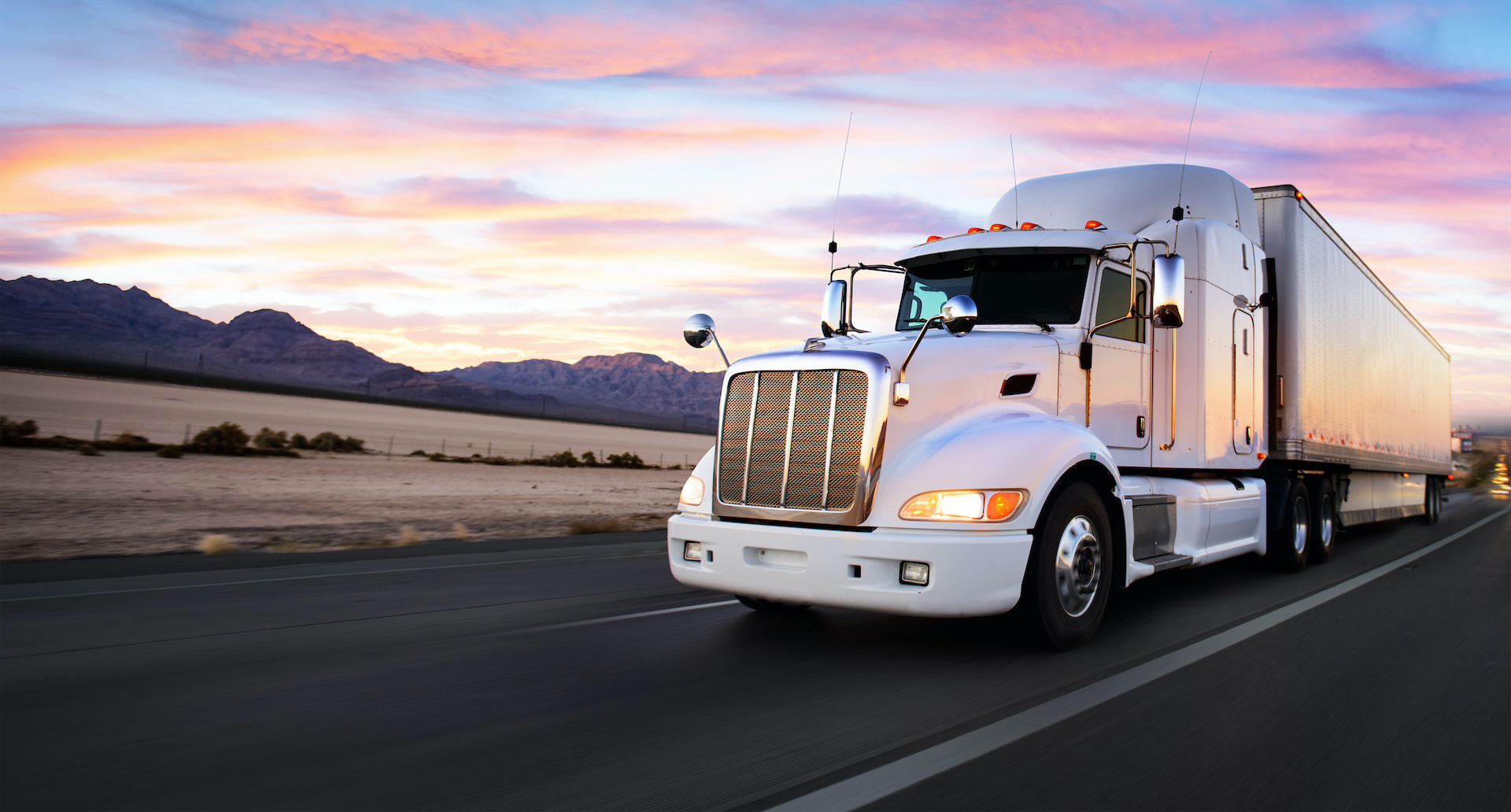 Truck and highway at sunset – transportation background