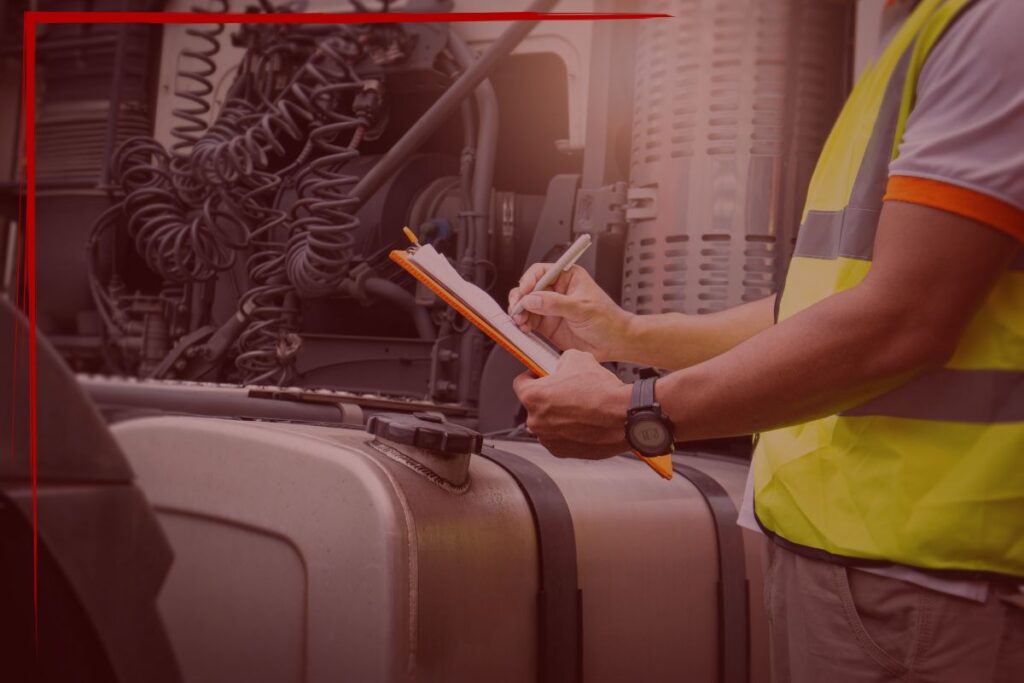 TT Blog - 0426-3 Trailer Transit Inc. | A person in a safety vest writes on a clipboard next to a truck with its hood open, carefully inspecting the vehicle demonstrating a benefit of hiring truck transportation services.