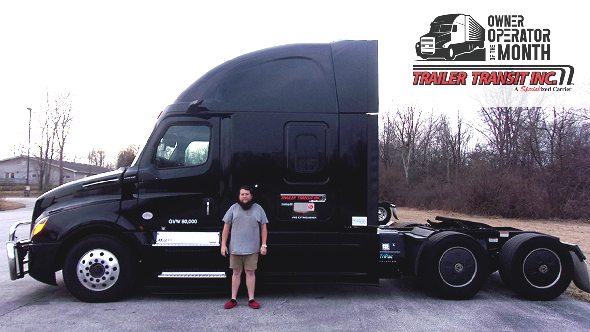 Trailer Transit Inc. | Sean, stands in front of his black semi-truck with “Trailer Transit Inc.” branding, honored as the Trailer Transit Owner Operator of the Month; a company award graphic appears in the upper right corner.