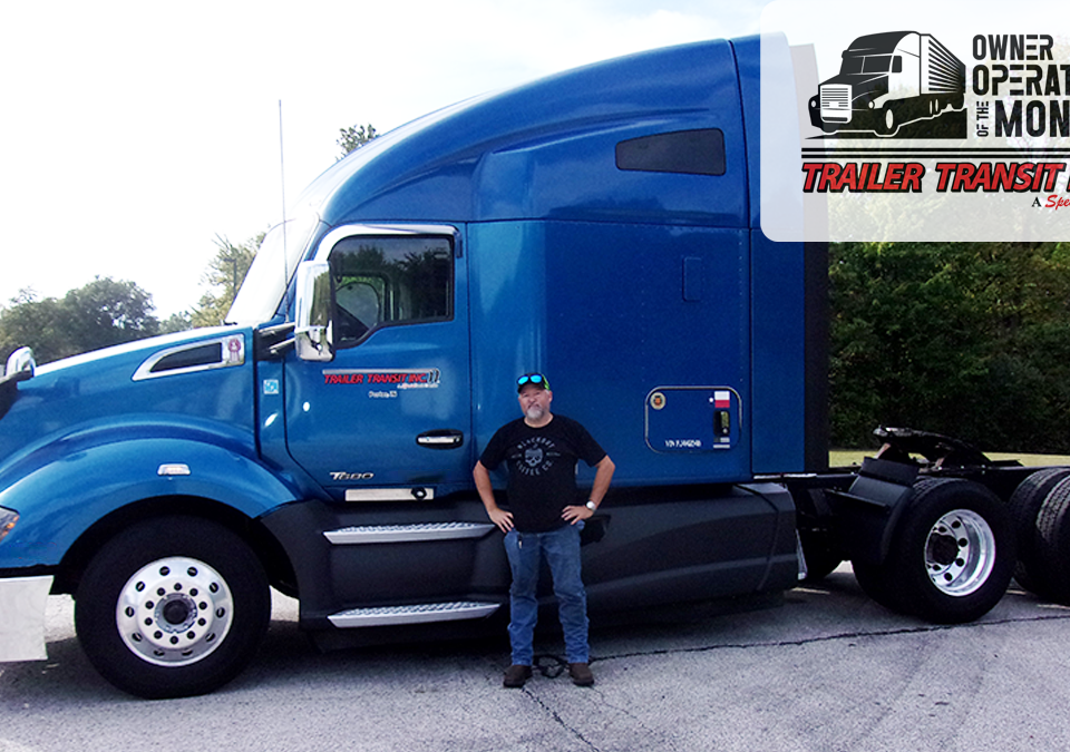 Trailer Transit, Inc. | Owner Operator of the Month, Jeff, stands in front of his blue semi tractor with green trees in the background and a badge at the top with Trailer Transit's Owner Operator of the Month logo.