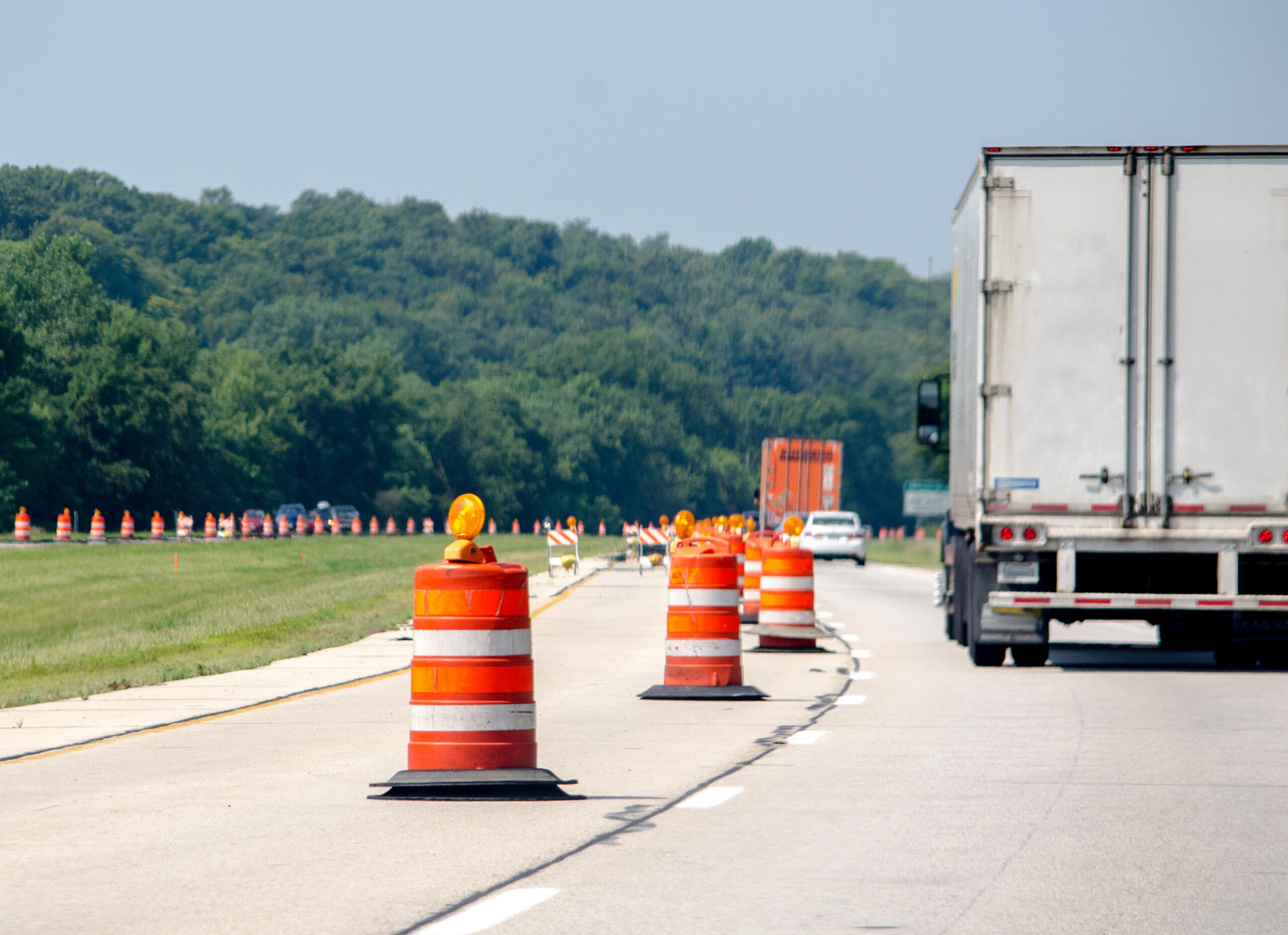 Trailer Transit, Inc. | Vehicles travel the USA highways as orange construction cones pop up all over, as road repairs begin