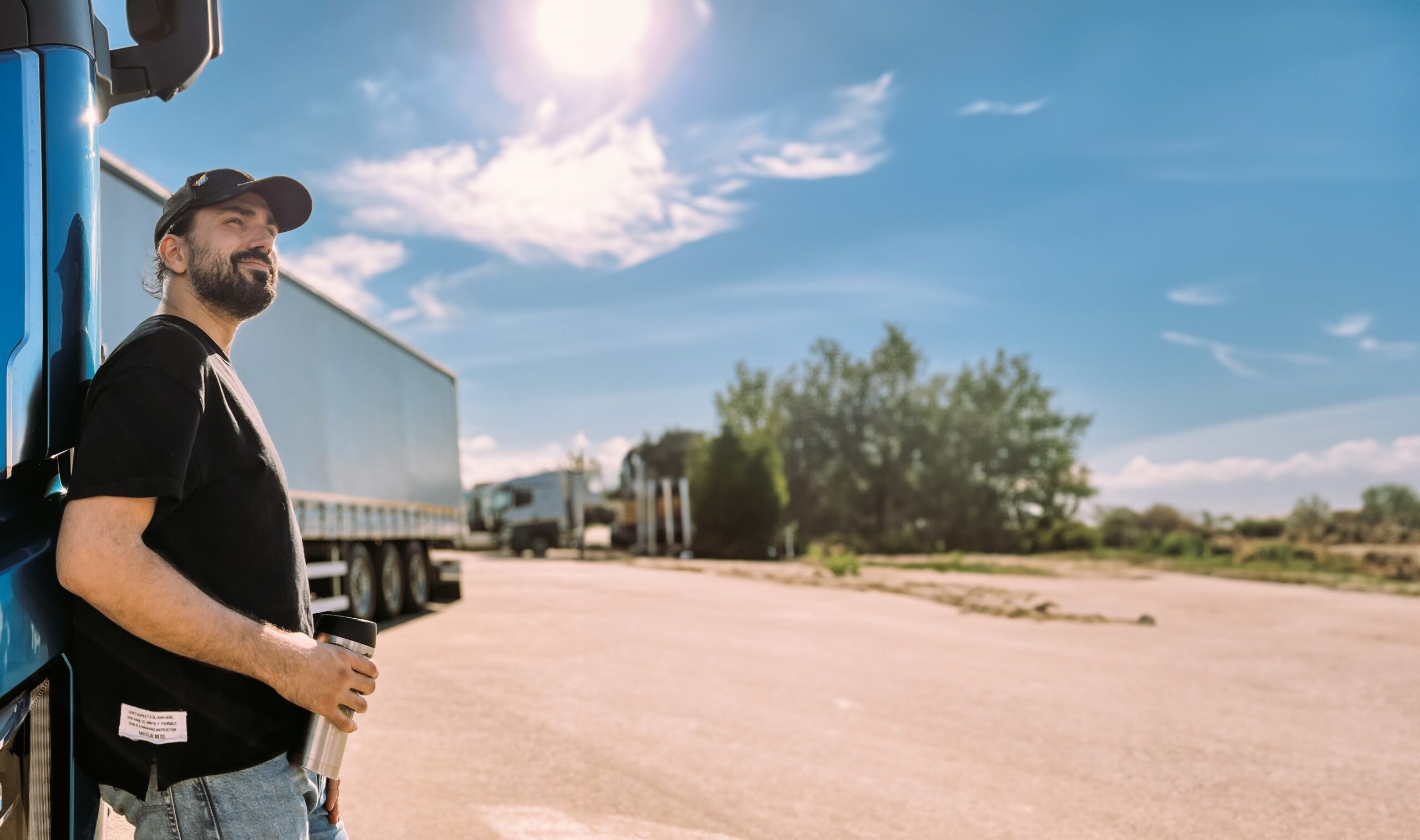 Trailer Transit, Inc. | A young man is a professional driver near a blue truck.